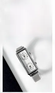 Detail of silver dual-dial rectangular watch with Milanese mesh strap and Roman numerals