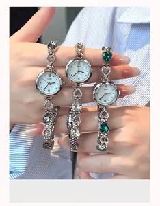 Detailed view of GEDI heart-shaped link bracelet watches with emerald and gray crystals