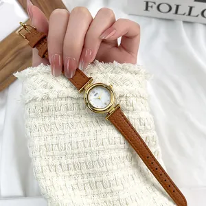 Elegant ladies quartz watch with gold case, mother of pearl dial and brown leather strap