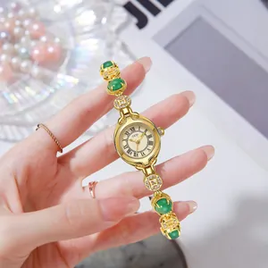Vintage style women gold quartz watch with emerald green stones and roman dial