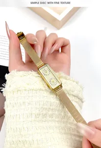 Close-up of gold rectangular dual-dial watch with mesh band and Roman numerals