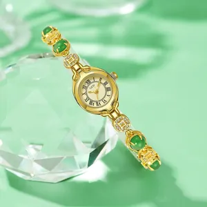 Vintage gold women's quartz watch with green jade-like stones and coin chain strap