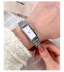 Elegant rectangle silver quartz watch with steel mesh band on a woman's wrist