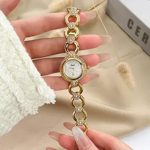 Elegante orologio da polso dorato da donna con cristalli scintillanti e quadrante bianco