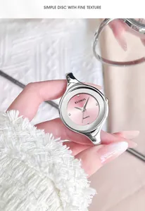 Close-up of elegant women's watch with light pink dial and polished silver bracelet