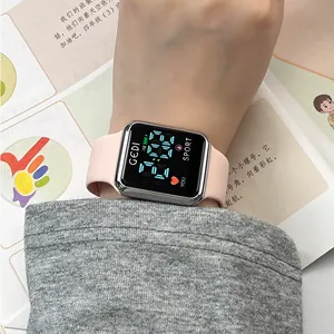 Pink silicone digital sports watch with square silver case on a female wrist