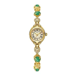 Vintage gold lady watch with green jade-style stones and Roman numeral dial
