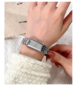 Close-up of elegant silver rectangular quartz watch with multi-row metal link bracelet