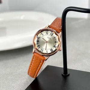 Orologio al quarzo retrò con cassa oro rosa, vetro sfaccettato e cinturino arancio