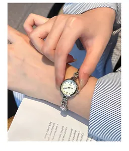 Close-up of GEDI silver bracelet watch with heart charm and mother of pearl dial