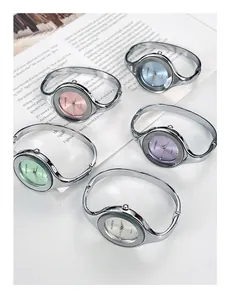 Detailed display of assorted bangle watches with colorful dials and silver metal bands