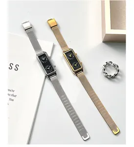 Close-up of rectangular dual-dial watches with Milanese mesh bands and twist ring