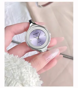 Detail of silver bangle watch featuring a purple sunray dial with sparkling crystal markers
