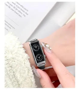 Detail shot of rectangular dual-dial silver mesh watch showing Roman and Arabic numerals
