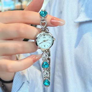 Elegant silver quartz watch for women with heart-shaped bracelet and blue rhinestone accents