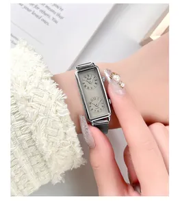 Detail of Gedi silver rectangular watch with dual dials and roman numerals on wrist