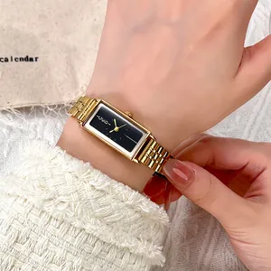 Elegant GEDI women's rectangular gold watch with black dial and chain strap on wrist