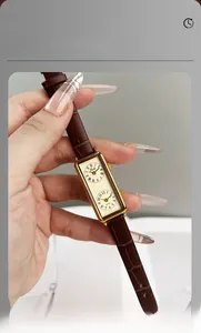 Detail of vintage rectangular quartz watch with dual dials and brown leather strap