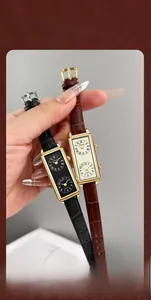 Close-up of dual-time rectangular quartz watches with leather straps for women