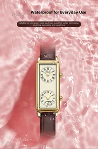 Close-up of dual-dial rectangular quartz watch with brown leather strap on water background