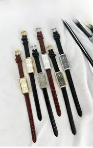 Detailed view of rectangular dual-dial quartz watches with alligator texture leather straps
