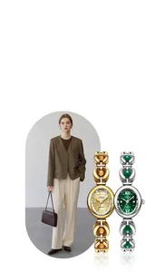 Detail of elegant gold and silver quartz watches featuring emerald and amber gemstone accents