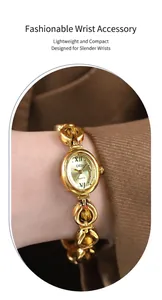 Detail of elegant gold quartz watch with emerald green beads on wrist