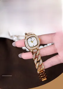 Close-up of luxury gold women watch with full rhinestones and Cuban link band detail