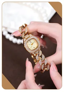 Close-up of Gedi gold-tone luxury watch with rhinestone-encrusted Cuban link strap