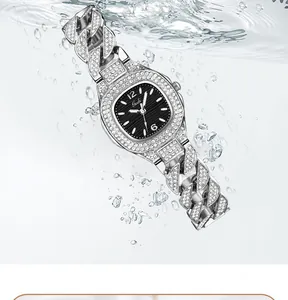 Macro view of silver luxury watch with diamond-encrusted bezel and black dial in water