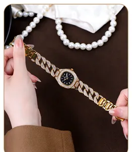 Close-up of luxury gold cuban link watch for women with sparkling crystal accents