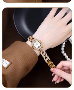 Detail of luxury gold wrist watch with sparkling rhinestones on chunky chain bracelet