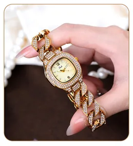 Detailed macro of a luxury gold Gedi watch featuring iced-out crystal Cuban chain strap