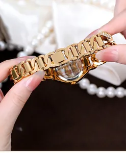 Close-up of the engraved stainless steel back and geometric bracelet link of the gold watch