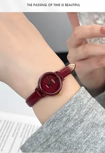 Elegant vintage lady watch with deep red dial and leather strap shown on wrist