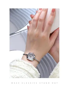 Elegant silver rope bracelet watch on a female wrist with minimalist square dial