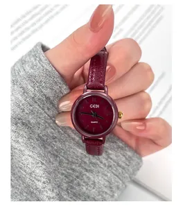 Close-up of GEDI quartz watch featuring a burgundy dial and matching leather strap