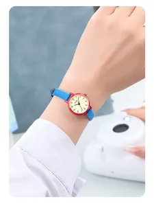 Gros plan de la montre GEDI avec boîtier rouge, bracelet en cuir bleu et cadran crème