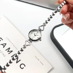 Elegant silver heart-shaped women's quartz watch with a beaded chain bracelet
