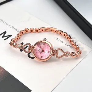 Detail of rose gold heart bracelet watch with pink pearl dial and quartz movement