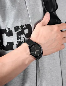 Close-up of GEDI minimalist sports watch with black silicone strap and rose gold hands