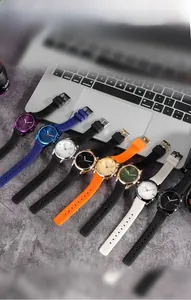 Selection of GEDI quartz watches with silicone straps in various colors on a laptop desk