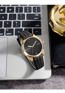 Macro view of GEDI quartz watch with black dial and rose gold case on keyboard