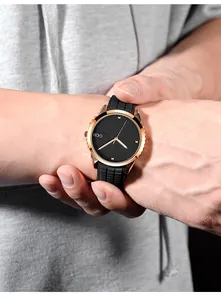 Close-up of GEDI watch featuring rose gold case and black silicone strap on wrist
