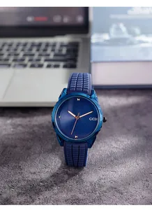 Navy blue quartz watch with spiral dial and silicone strap shown in lifestyle setting