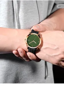 Detail of GEDI sports watch featuring a green radial dial and rose gold case