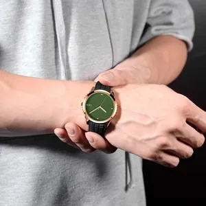 Minimalist quartz watch with rose gold alloy case, green dial and black silicone strap