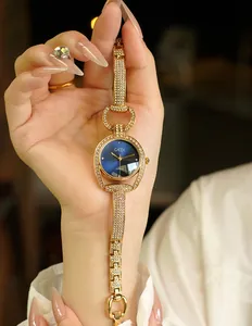Detailed view of women's gold rhinestone bracelet watch with navy starry sky dial