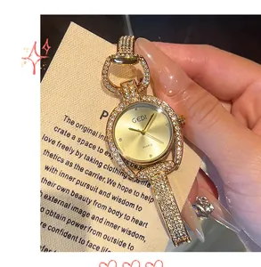 Close-up of GEDI horseshoe-shaped watch with crystal-encrusted bezel and gold dial