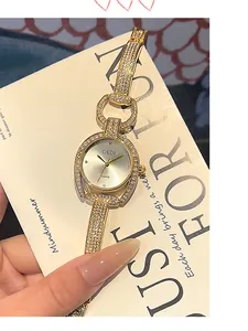 Detailed close-up of a luxury gold watch featuring sparkling rhinestones and a unique case